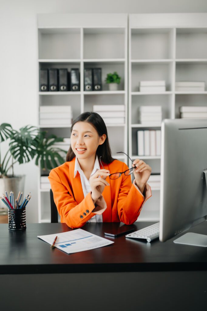 Professional woman working in her office, reviewing documents and focused on her tasks.