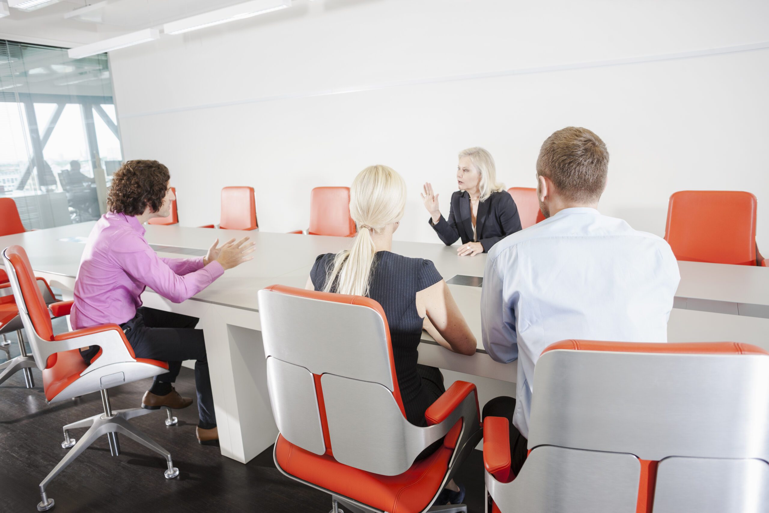 A family office meeting with professionals discussing wealth management strategies and financial planning.