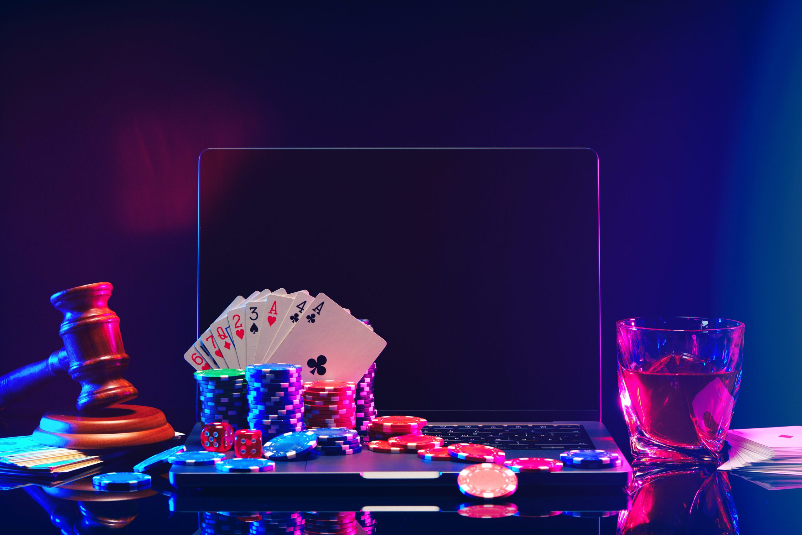 An energetic, modern iGaming scene featuring a roulette table, poker chips, playing cards, and a sports betting screen. Digital elements, such as a smartphone displaying an online casino, add a futuristic touch, with neon lights and gaming icons representing the virtual gaming world.