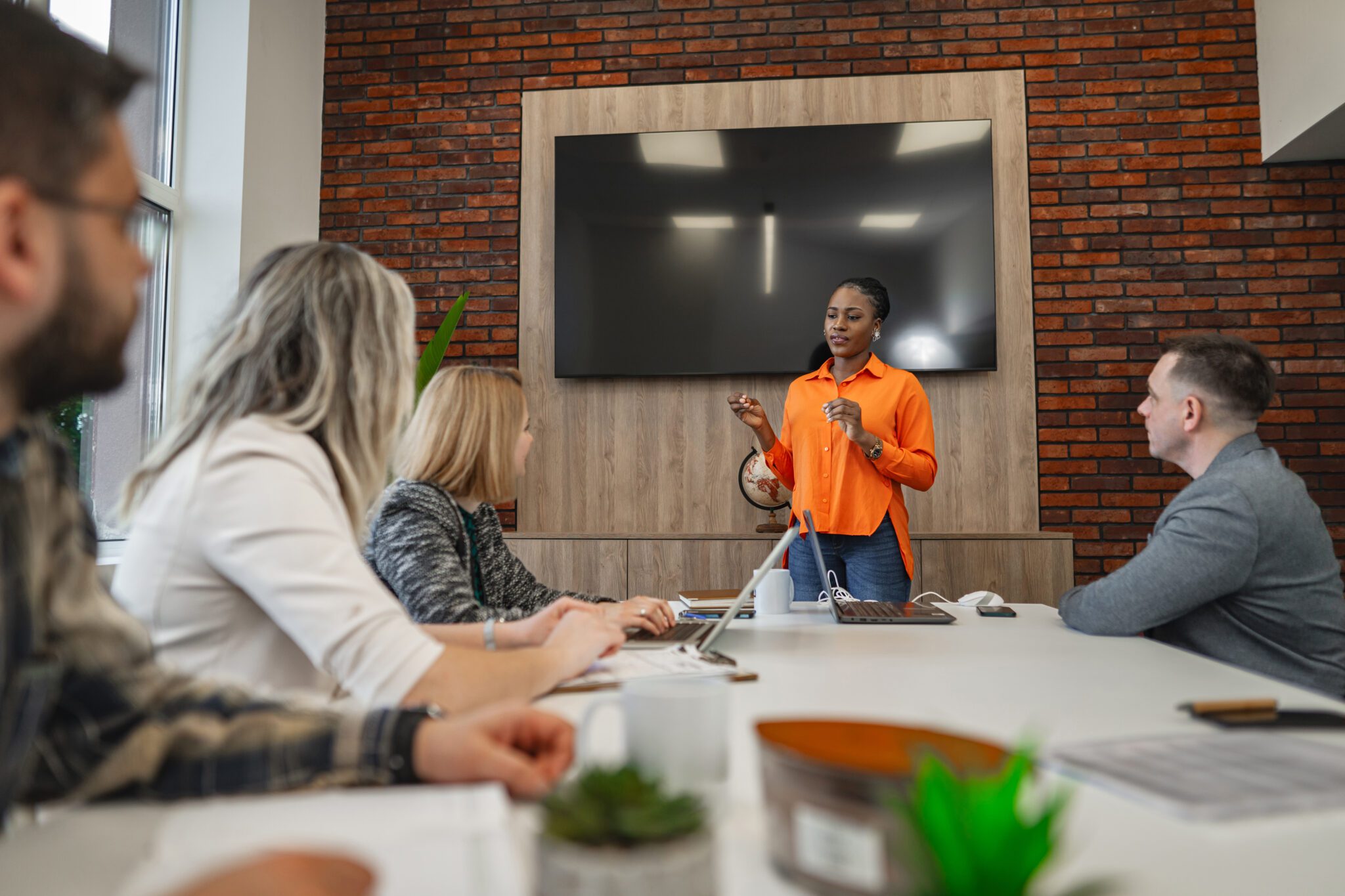 Business professionals in a corporate meeting discussing corporate services and strategic business solutions.
