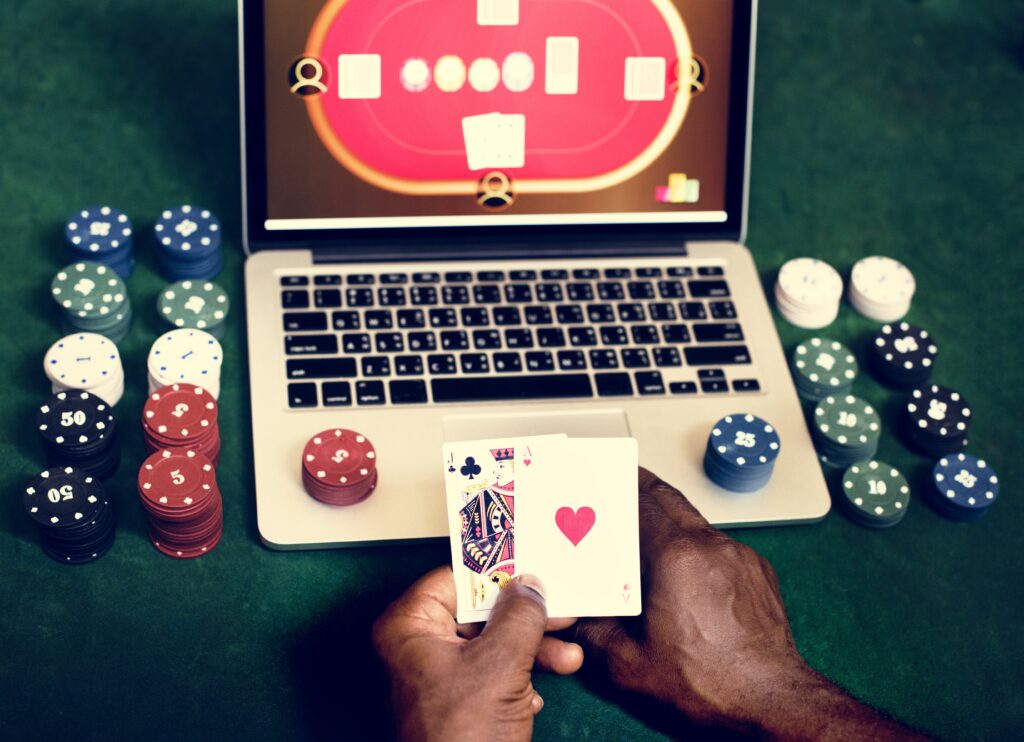 A dynamic online poker scene featuring a digital poker table with cards and chips, along with a smartphone or tablet displaying an online poker game. Neon lighting creates a modern, futuristic atmosphere, capturing the excitement and strategy of poker in a sleek, digital environment.