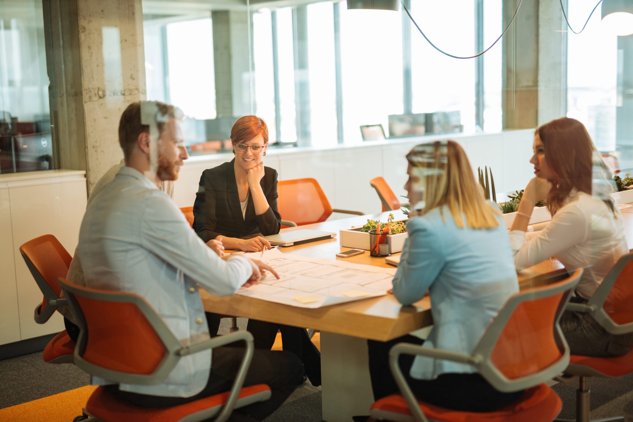 Professional team collaborating in a corporate office, ensuring compliance services meet regulatory standards and business requirements.
