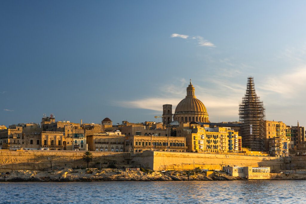Stunning view of Malta's picturesque coastline and historic architecture, showcasing the advantages of residency and citizenship programmes in Malta
